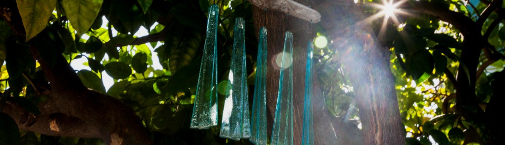 Teal Glass Wind Chimes Hanging from Grapefruit Tree